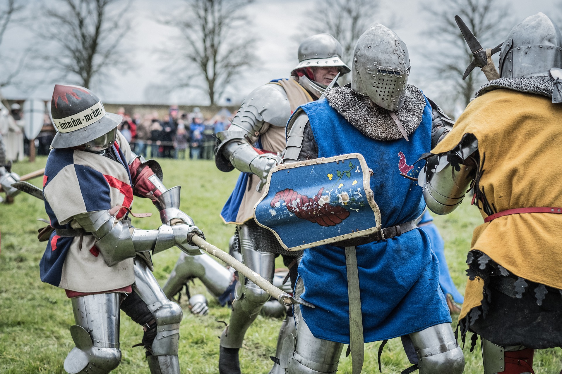 Medieval battle re-enactment showing four participants in mock battle.